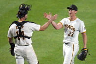 Pittsburgh Pirates pitcher Mitch Keller (23) celebrates with catcher Joey Bart after getting a complete game win over the Los Angeles Angels in a baseball game in Pittsburgh, Monday, May 6, 2024. (AP Photo/Gene J. Puskar)