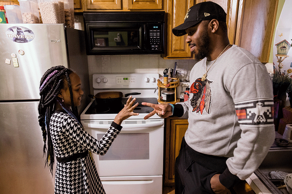 Parker and his daughter in the kitchen before headling out. (Rosem Morton for NBC News)