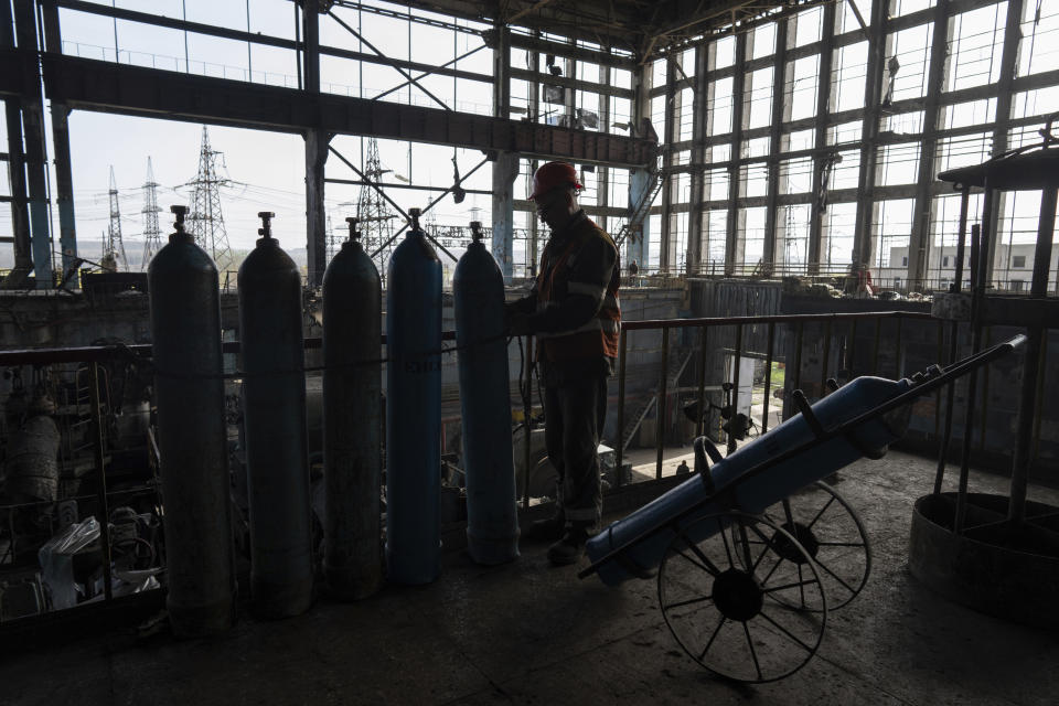 A worker prepares balloons with oxygen for welders to clear rubble after a Russian missile attack at DTEK's power plant in Ukraine, on Tuesday, April 2, 2024. Russia is attacking Ukraine’s energy sector with renewed intensity and alarming accuracy, signaling to Ukrainian officials that Russia is armed with better intelligence and fresh tactics in its campaign to annihilate the country’s power generation capacity. (AP Photo/Evgeniy Maloletka)