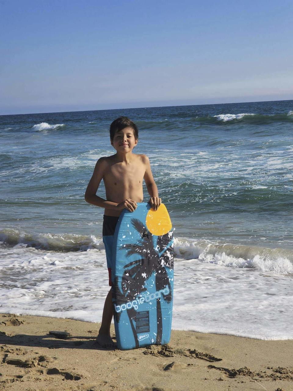 Honor Beauvais, 12- year-old, visits Huntington Beach in Southern California, in August 2022. Honor loved his annual vacation to the California beaches. Beauvais died last month as a snow battered the Rosebud Sioux Reservation in South Dakota after an ambulance couldn’t get to him in time. He was asthmatic and had influenza. (Cordier Beauvais via AP)