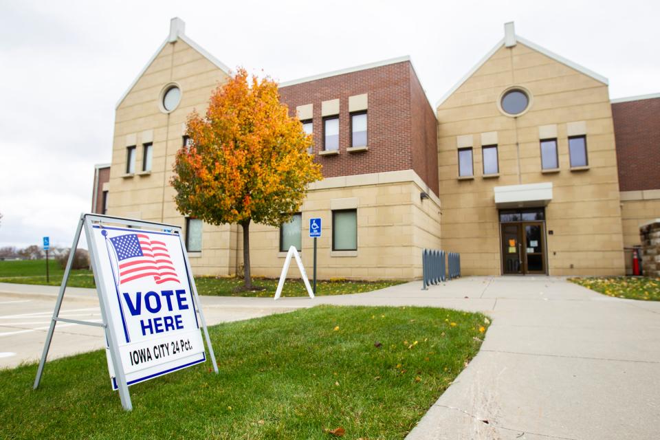 A voting sign directs people towards Iowa City precinct 24 on Tuesday, Nov. 6, 2018, at St. Patrick's Church in Iowa City.