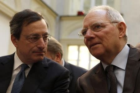 German Finance Minister Wolfgang Schaeuble (R) talks to European Central Bank (ECB) President Mario Draghi (C) during a discussion in Berlin, December 15, 2011. REUTERS/Fabrizio Bensch