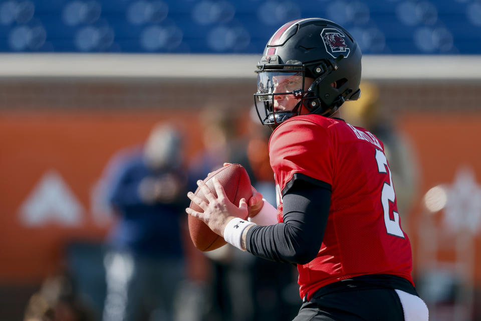 American quarterback Spencer Rattler, of South Carolina, drops back to pass during practice for the Senior Bowl NCAA college football game, Tuesday, Jan. 30, 2024, in Mobile, Ala. (AP Photo/ Butch Dill)