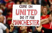 <p>Manchester United fan with a banner in tribute to the victims of the Manchester attack. Reuters / Lee Smith Livepic </p>