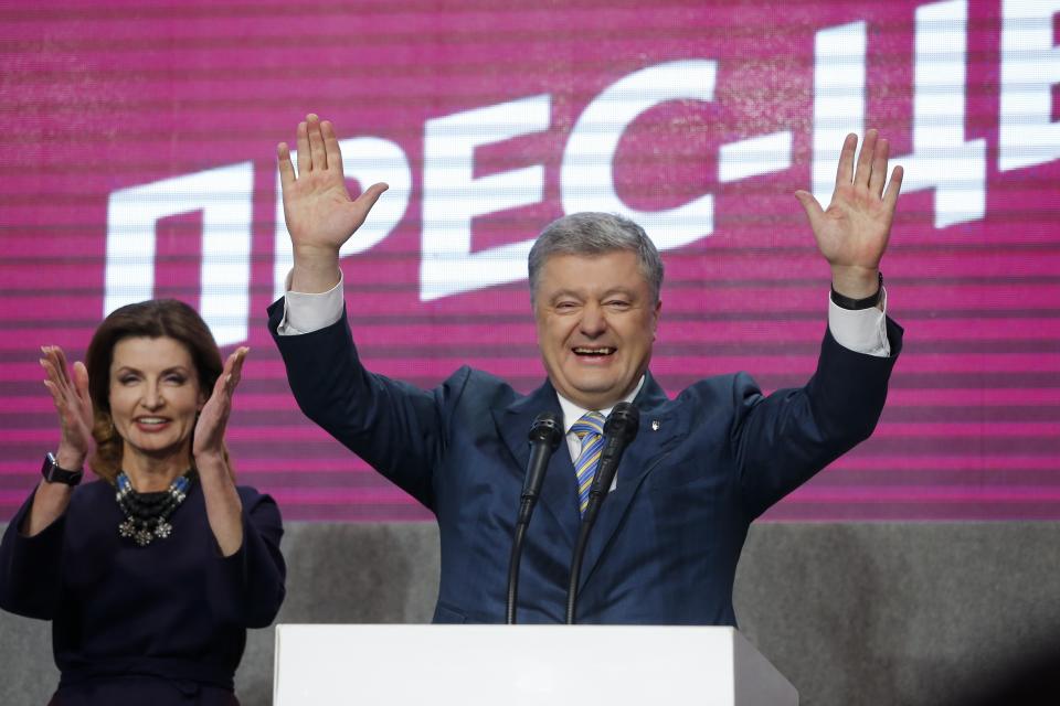 Ukrainian President Petro Poroshenko and his wife Maryna greet their supporters at his headquarters after the second round of presidential elections in Kiev, Ukraine, Sunday, April 21, 2019. Ukrainian President Petro Poroshenko is accepting defeat in the election for the country's top post. (AP Photo/Efrem Lukatsky)