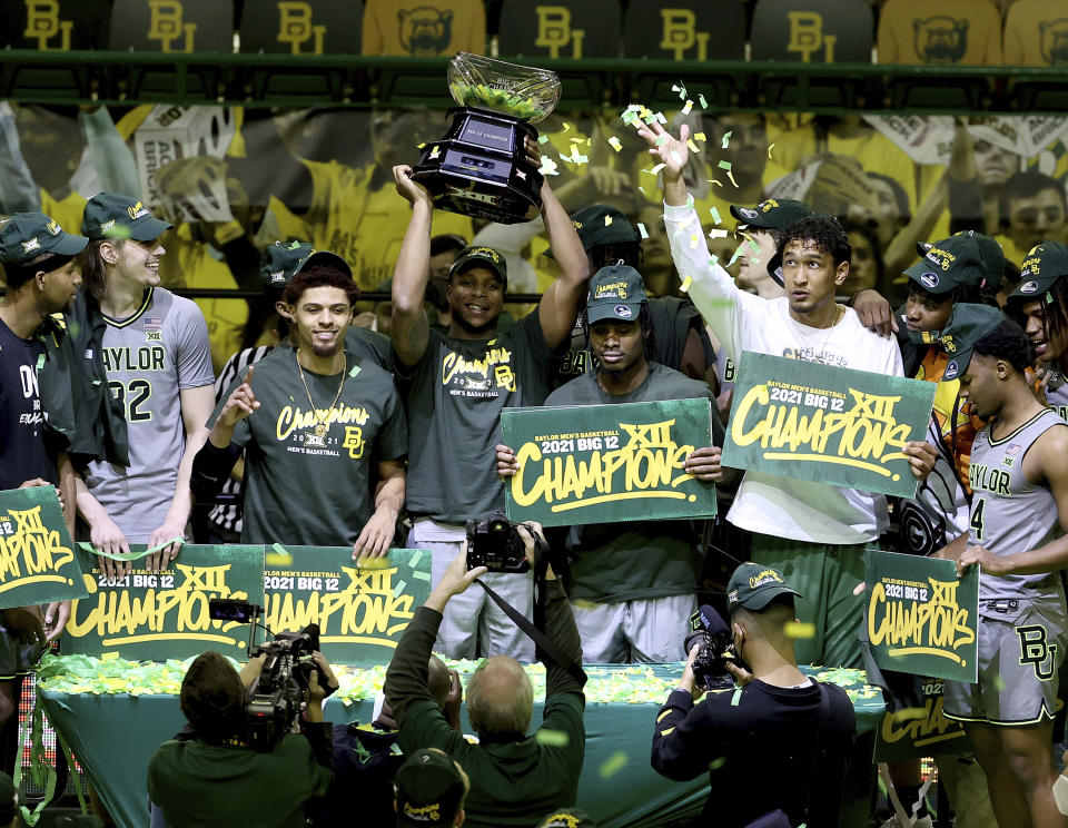 Baylor players celebrate their Big 12 championship which they won against West Virginia after their NCAA college basketball game against Texas Tech Sunday, March 7, 2021, in Waco, Texas. (AP Photo/Jerry Larson)