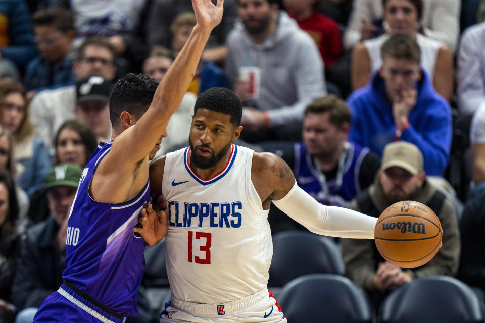 Utah Jazz forward Simone Fontecchio. Left, defends as Los Angeles Clippers forward Paul George (13) makes a move to the basket, during the first half of an NBA basketball game Friday, Dec. 8, 2023, in Salt Lake City. (AP Photo/Rick Egan)