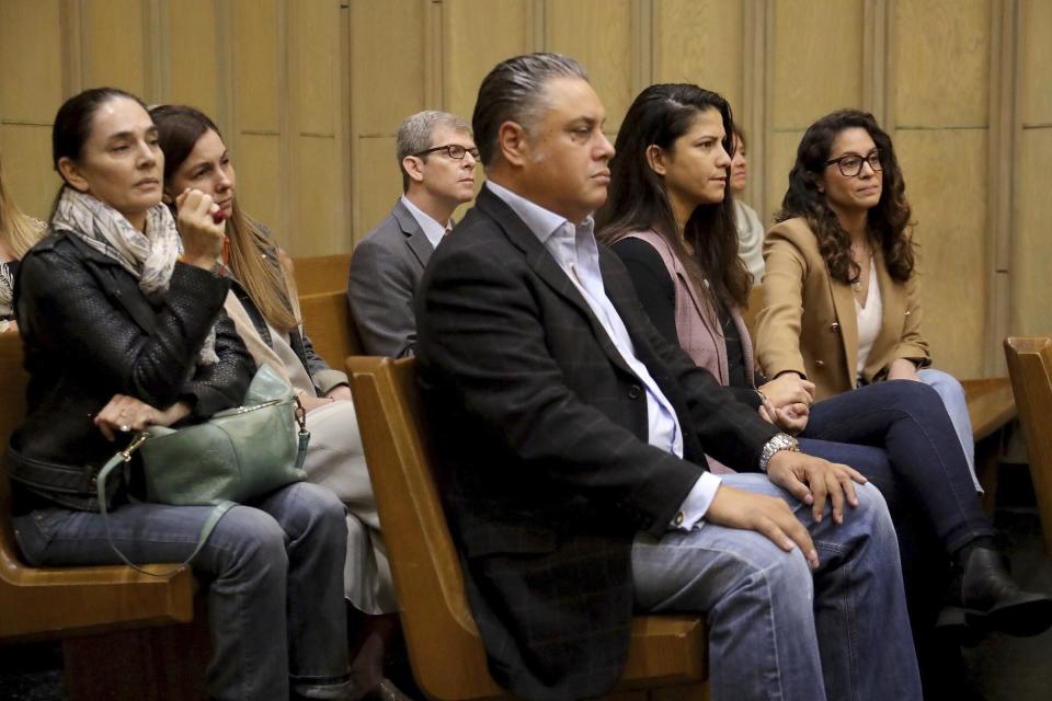 Family members listen as Judge Maria Tinkler Mendez ruled against a new trial for Mexican actor Pablo Lyle as he, his family, lawyers, and members of the media gathered in Courtroom 4-6 at the Richard E. Gerstein Justice Building in Miami, Fla. on Monday, Dec. 12, 2022. (Carl Juste/Miami Herald via AP)