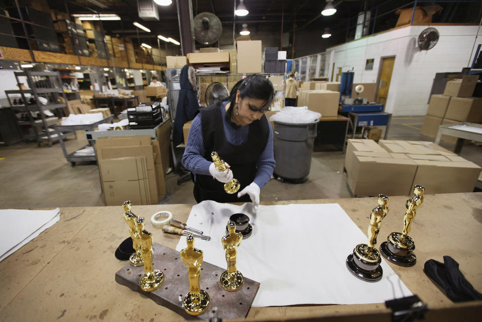 CHICAGO, IL - FEBRUARY 09: Josefina Govea assembles an Oscar statuette at R.S. Owens & Company February 9, 2012 in Chicago, Illinois. R.S. Owens manufactures the Oscar statuettes which are presented at the annual Academy Awards by the Academy of Motion Picture Arts and Sciences. After the theft of the statuettes prior to the 2000 Academy Awards the company began casting the statuettes one year in advance of the show. (Photo by Scott Olson/Getty Images)