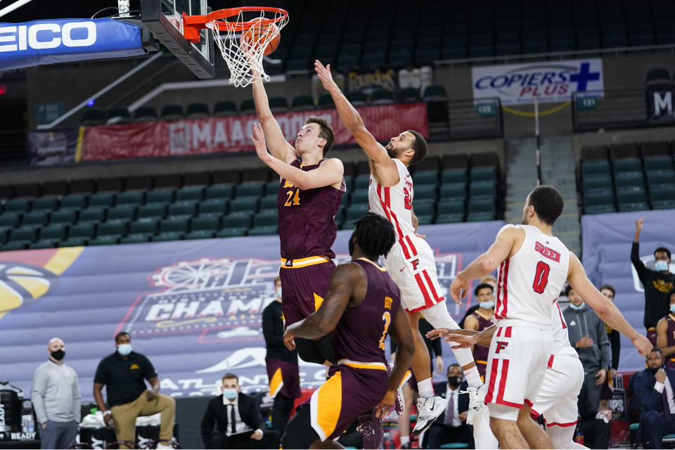 Iona's Dylan van Eyck, left, goes up for a shot past Fairfield's Jesus Cruz in the second half of an NCAA college basketball game during the finals of the Metro Atlantic Athletic Conference tournament, Saturday, March 13, 2021, in Atlantic City, N.J. (AP Photo/Matt Slocum)