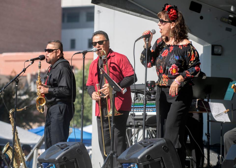 The Latin Soul band performs at the Mexican Heritage Center's 4th annual De Los Muertos Street Fiesta in downtown Stockton on Oct. 28, 2023. The event, at the intersection of Market and Sutter streets, celebrates Mexican culture and remembers past ancestors. Altars, or offends were on display as well as the car show. A Catrina pageant accompanied musical acts as well as food and crafts vendors.