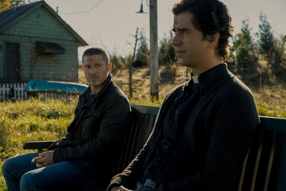 Father Paul (Hamish Linklater, right) tries to reach out and bond with the returned Riley (Zach Gilford) in "Midnight Mass."