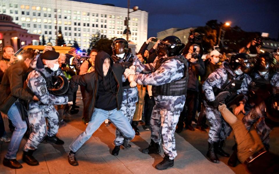 Police detain a man during a protest against the partial military mobilisation. - Alexander Nemenov/AFP