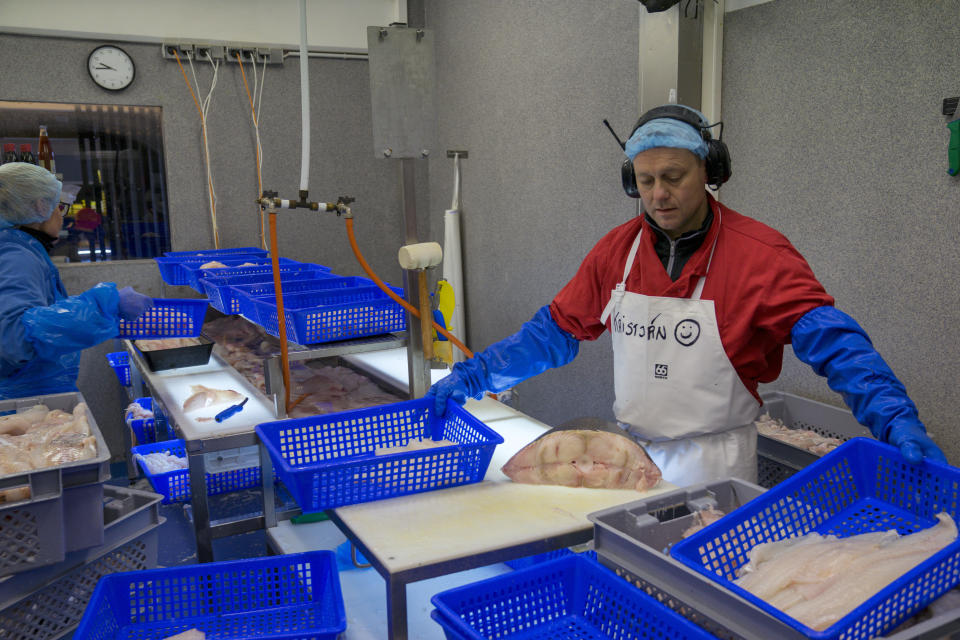 In this photo taken Monday Oct. 28, 2019, fishmonger Kristjan Asgeirsson is seen at work in Reykjavik, Iceland. Asgeirsson lost $68,000 in an online scam. The people of Iceland, who speak a unique dialect of Old Norse, are no longer protected from online fraud because of their linguistic isolation. Modern computer programs, sophisticated auto-translation systems and increased procession speed, has made residents much more vulnerable to computer scams. Recent scams have amounted to the largest thefts the island nation has ever seen. (AP Photo/Egill Bjarnason)
