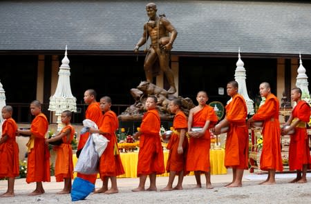 Members of the Wild Boars soccer team return one year after their rescue from the caves in Tham Luang