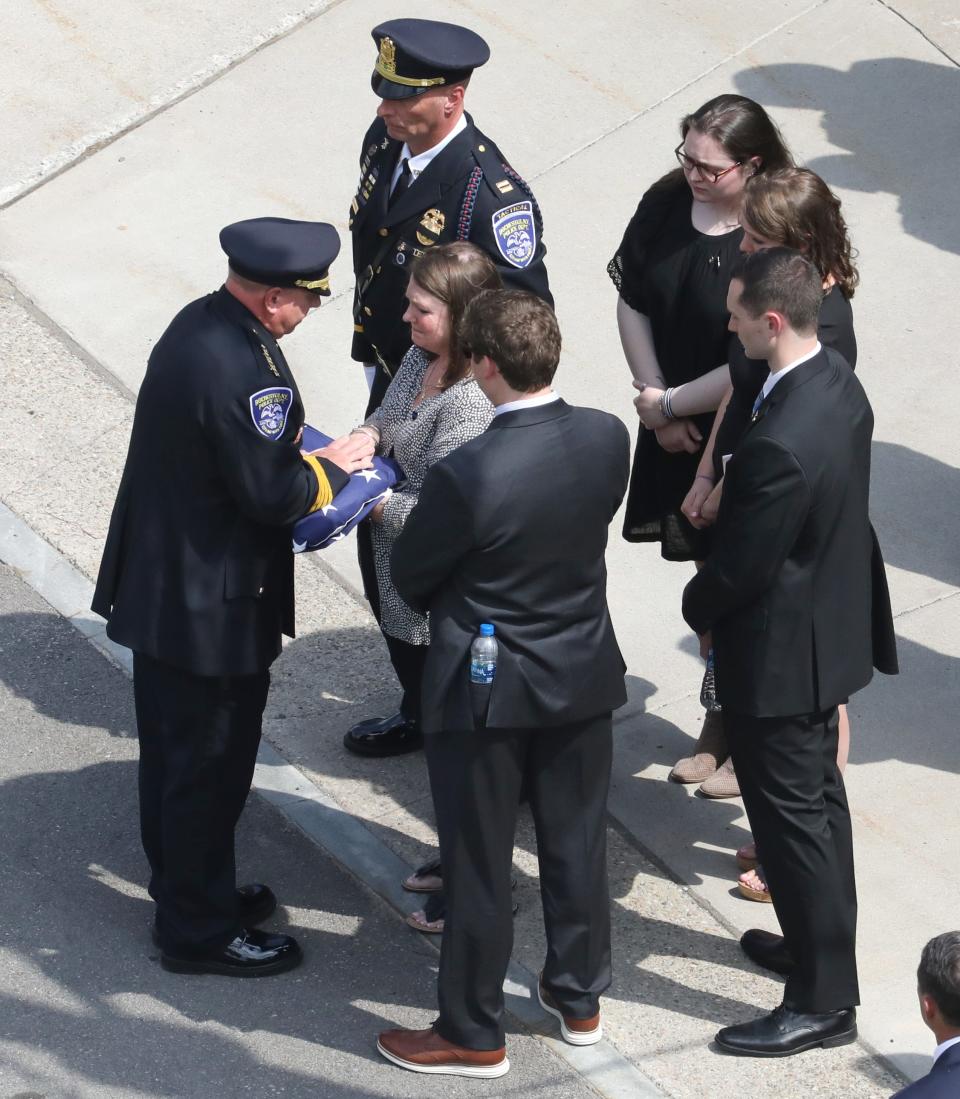 The folded  American flag from the casket of Rochester Police Officer Anthony Mazurkiewicz is presented to his family at the end of his funeral service at the Blue Cross Arena Monday, Aug. 1, 2022 in downtown Rochester. 