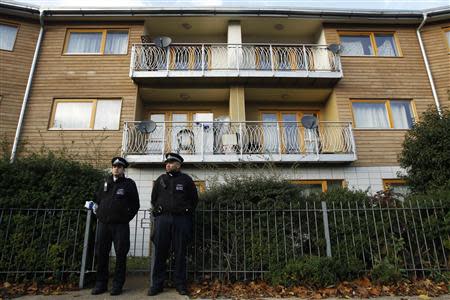 Police stand guard in front of a property in Lambeth, south London November 23, 2013. REUTERS/Luke MacGregor