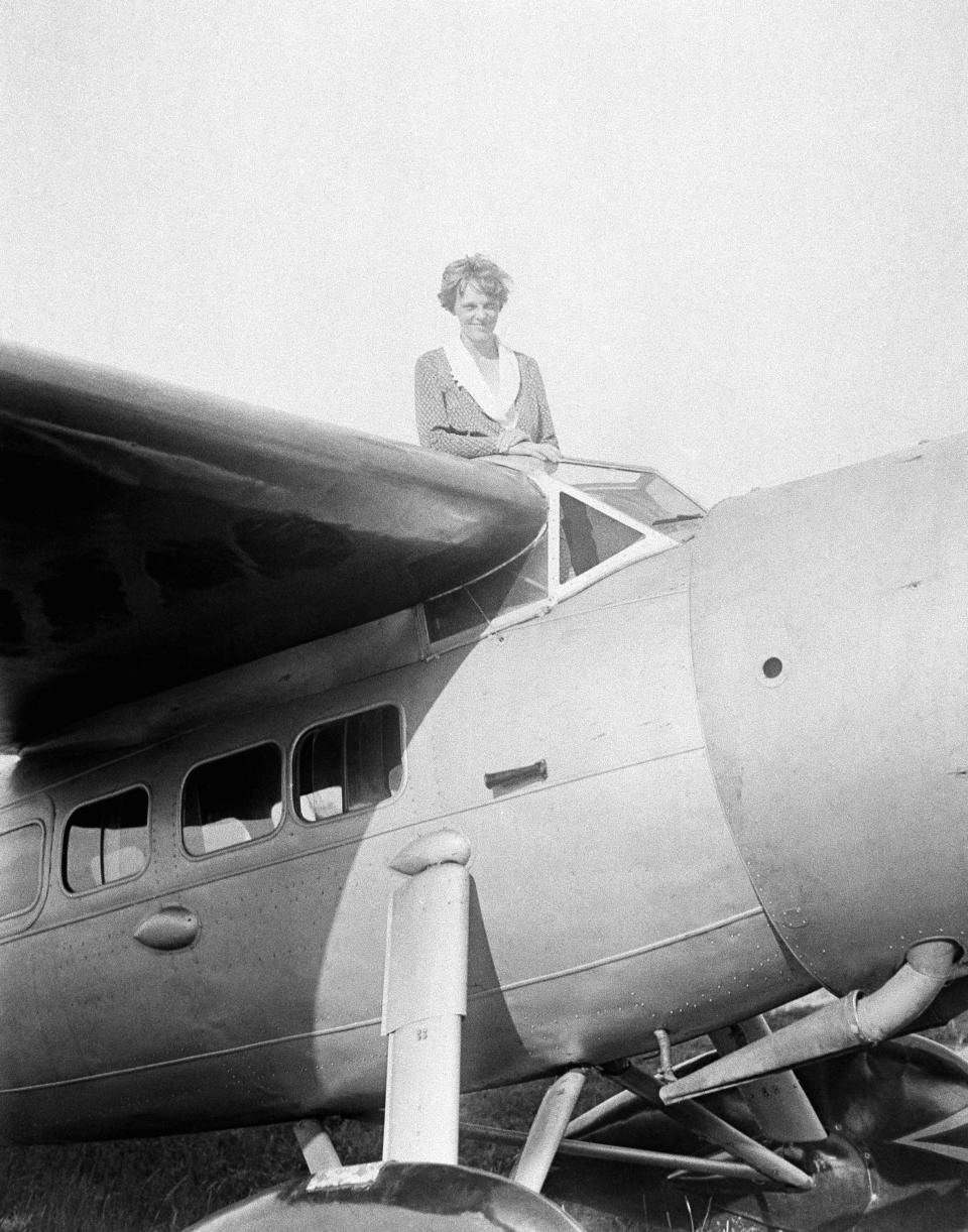 FILE - In this undated photo, Amelia Earhart, the first woman to cross the Atlantic Ocean by plane sits on top of a plane. Secretary of State Hillary Rodham Clinton is wading into one of the 20th century’s most enduring mysteries: the fate of American aviator Amelia Earhart, disappeared over the South Pacific 75 years ago. Clinton is meeting March 20, 2012, with historians and scientists from The International Group for Historic Aircraft Recovery, which will launch a new search in June for the wreckage of Earhart’s plane off the remote island of Nikumaroro. (AP Photo)