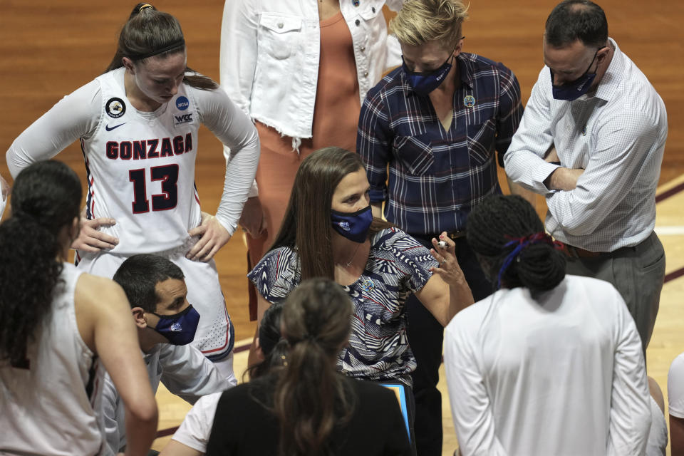 Gonzaga head coach Lisa Fortier, center, talks to her team during the first half of a college basketball game against Belmont in the first round of the women's NCAA tournament at the University Events Center in San Marcos, Texas, Monday, March 22, 2021. (AP Photo/Chuck Burton)