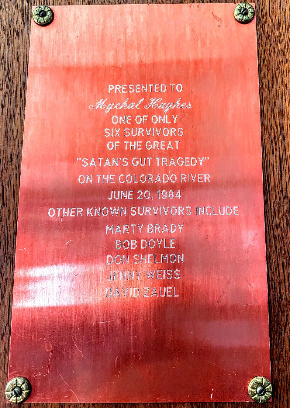 This plaque commemorating “the only time I ever flipped a boat” hangs on river runner Myke Hughes’ office wall, remembering the high water of 1984. | Lee Benson, Deseret News