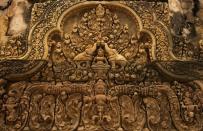 Detail of a rich carving at Banteay Srei shows how red sandstone can be carved almost like wood.