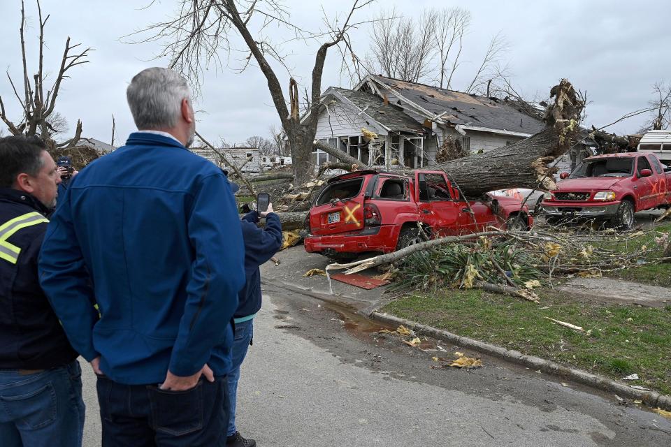 Sullivan Mayor Clint Lamb and Indiana Governor Eric Holcomb survey the damage caused by a tornado on Saturday, April 1, 2023 in Sullivan, Indiana.