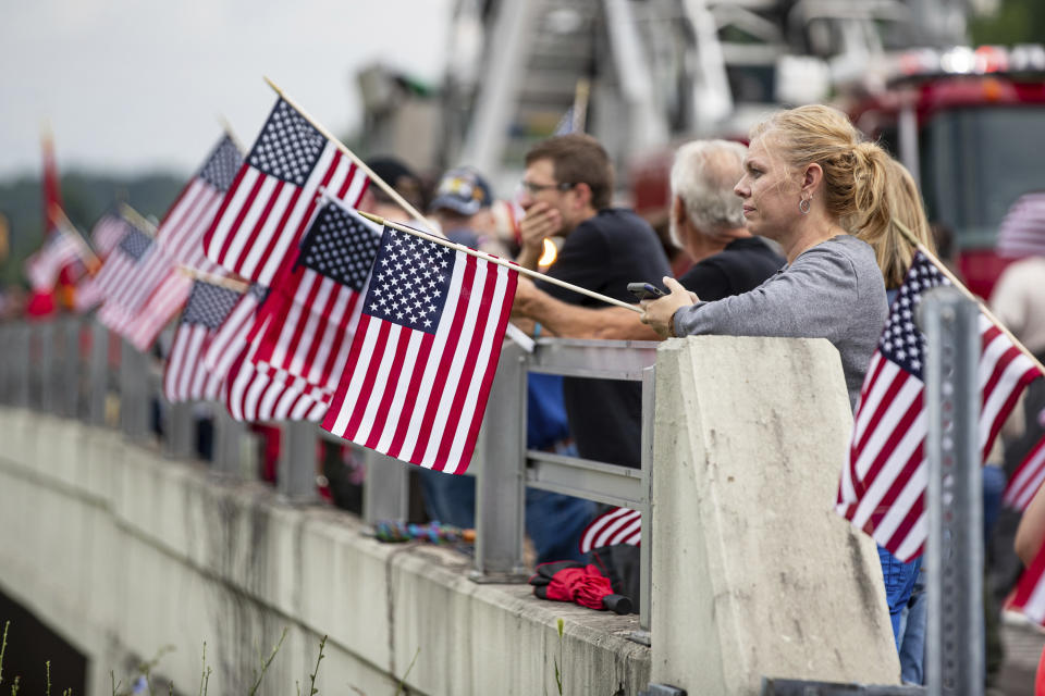 Area residents arrive to show their respect before the funeral procession for Medal of Honor recipient Hershel "Woody" Williams passes by on Saturday, July 2, 2022, in Teays Valley, W.Va. (Sholten Singer/The Herald-Dispatch via AP)
