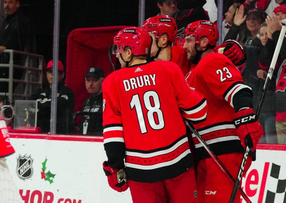 Dec 15, 2023; Raleigh, North Carolina, USA; Carolina Hurricanes right wing Stefan Noesen (23) celebrates his goal with center Martin Necas (88) and center Jack Drury (18) against the Nashville Predators during the first period at PNC Arena. Mandatory Credit: James Guillory-USA TODAY Sports