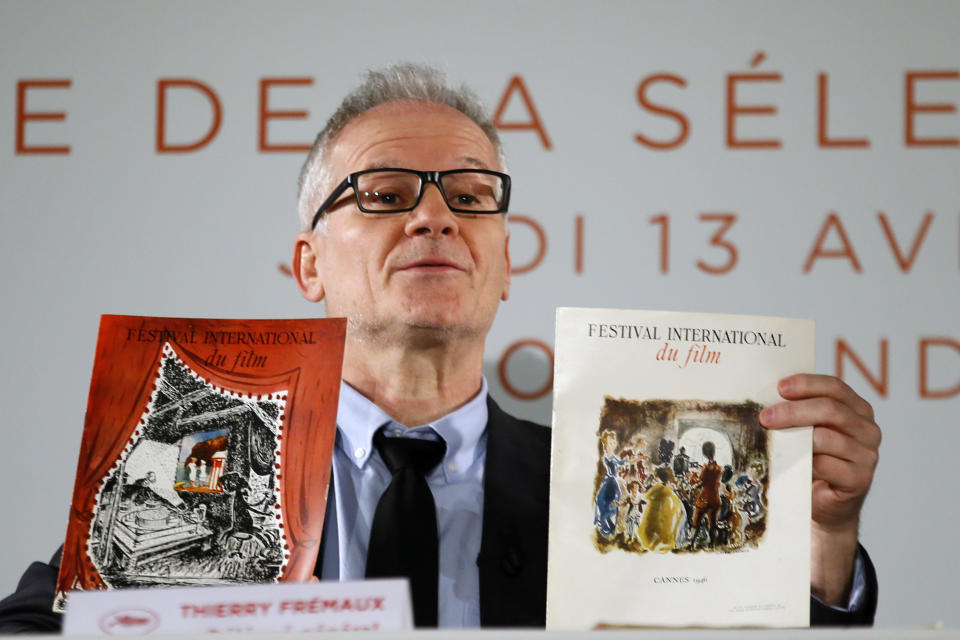 General Delegate of the Cannes Film Festival Thierry Fremaux displays 1946th Cannes festival books during a press conference for the presentation of the 70th Cannes film festival, in Paris, Thursday, April 13, 2017. A Civil War film by Sofia Coppola, a Ukrainian road movie and a film about AIDS activism are among 18 films competing for the top prizes at this year's Cannes Film Festival, which organizers hope can help counter nationalist sentiment. (AP Photo/Francois Mori)