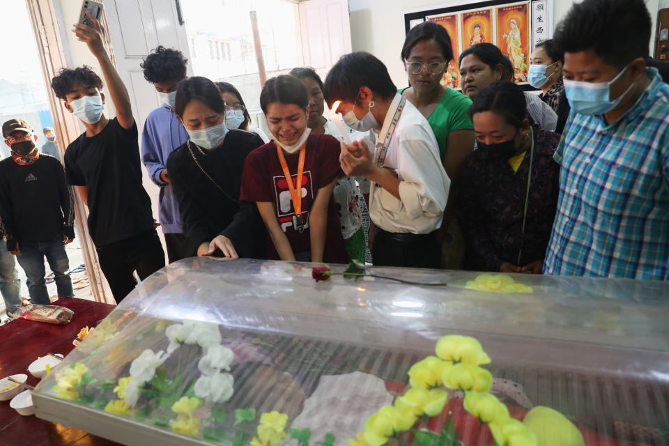 People mourn as they view the body of Kyal Sin, also known by her Chinese name Deng Jia Xi, a 20-year-old university student who was shot in the head while she attended an anti-coup protest rally in Mandalay, Myanmar Wednesday, Mar. 3, 2021. The army takeover in Myanmar a year ago that ousted the elected government of Aung San Suu Kyi brought a shocking end to the effort to restore democratic rule in the Southeast Asian country after decades of military rule. But at least as surprising has been the level of popular resistance to the seizure of power, which has blossomed into an insurgency that raises the specter of a protracted civil war. (AP Photo)