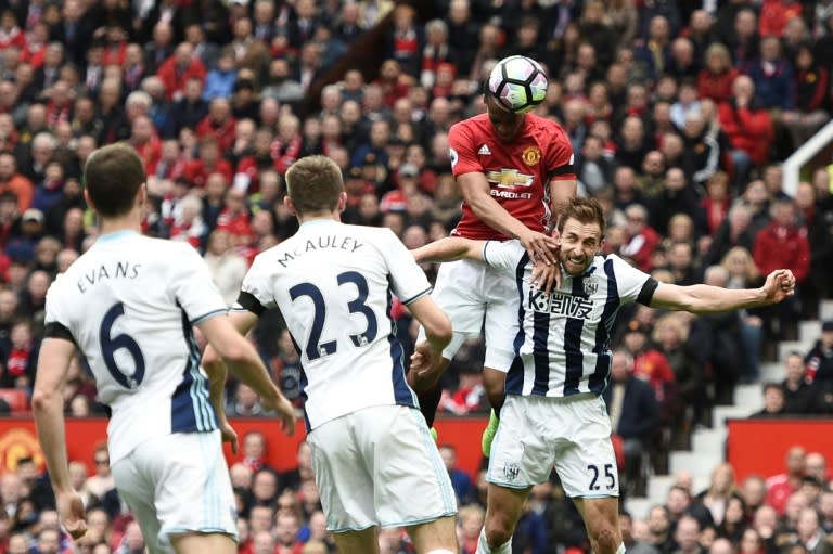 Manchester United's Anthony Martial (2R) climbs above West Bromwich Albion's Craig Dawson (R) but heads wide during their match at Old Trafford on April 1, 2017