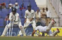 India's wicketkeeper Wriddhiman Saha (L) makes an unsuccessful attempt to run-out South Africa's Jean-Paul Duminy (R) as India's Ajinkya Rahane watches during the third day of their third test cricket match in Nagpur, India, November 27, 2015. REUTERS/Amit Dave