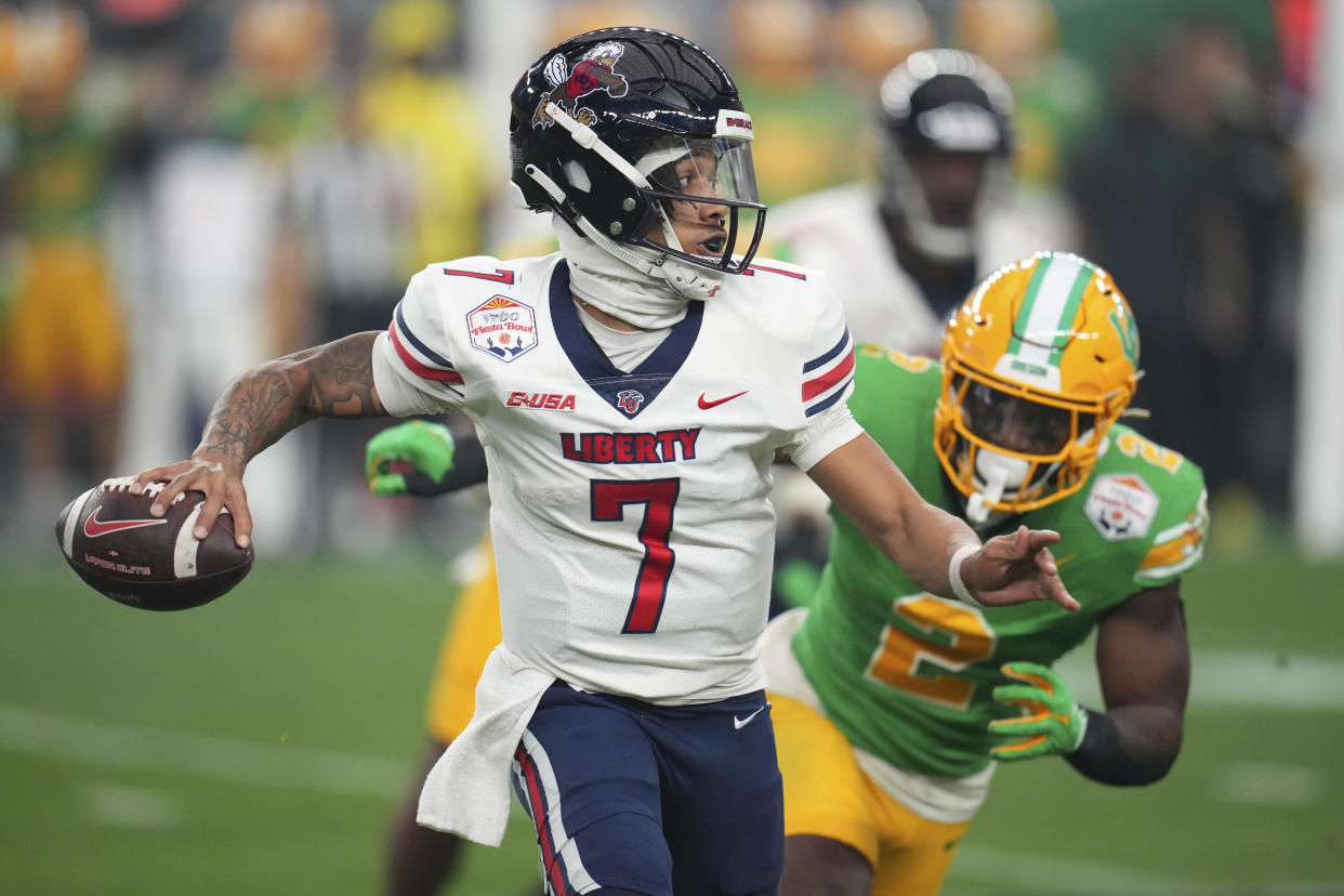 Liberty quarterback Kaidon Salter (7) scrambles during the first half on the NCAA Fiesta Bowl college football game against Oregon Monday, Jan. 1, 2024, in Glendale, Ariz. (AP Photo/Ross D. Franklin)