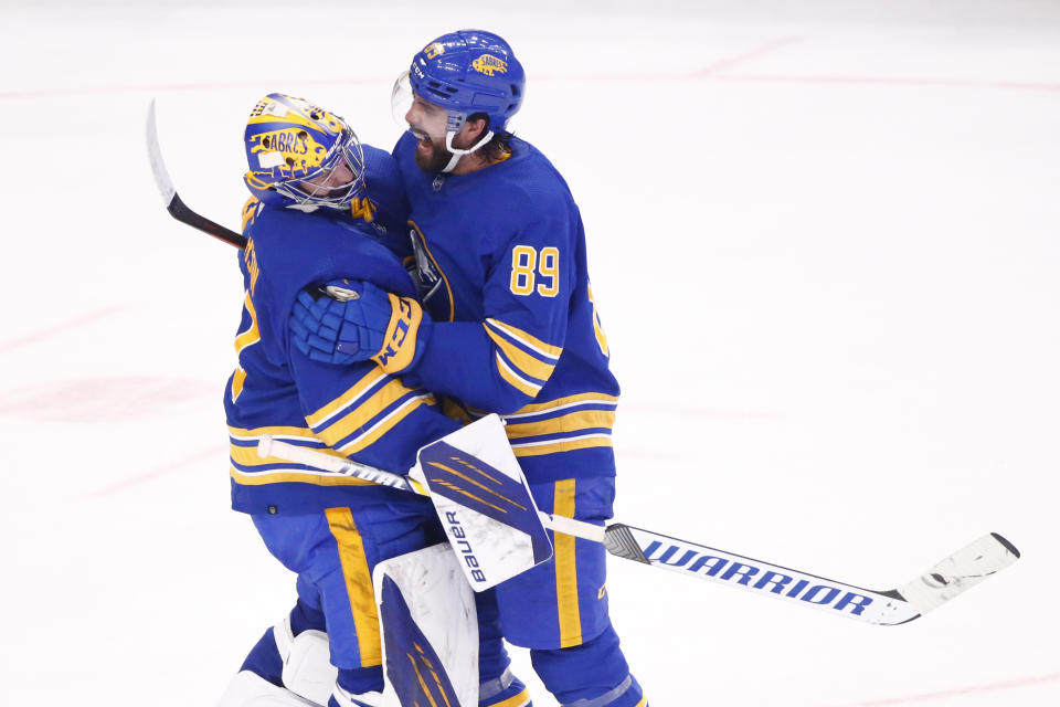 Buffalo Sabres goaltender Craig Anderson (41) and right wing Alex Tuch (89) celebrate their victory following the third period of an NHL hockey game against the Vega Golden Knights, Thursday, March 10, 2022, in Buffalo, N.Y. (AP Photo/Jeffrey T. Barnes)