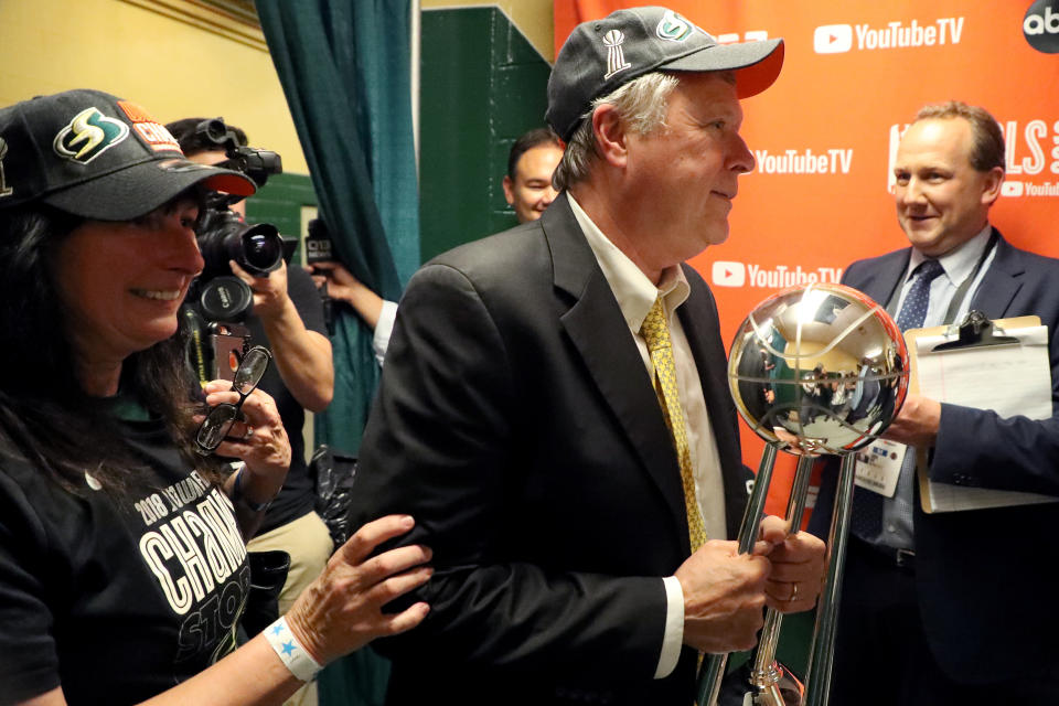 FAIRFAX, VA - SEPTEMBER 12: Head coach Dan Hughes of the Seattle Storm carries the trophy into the locker room after defeating the Washington Mystics to win the WNBA Finals at EagleBank Arena on September 12, 2018 in Fairfax, Virginia. (Photo by Rob Carr/Getty Images)