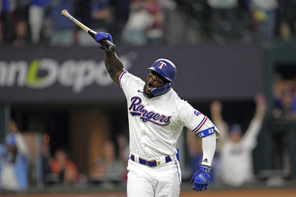 Texas Rangers' Adolis Garcia celebrates after hitting a three-run home run against the Houston Astros during the sixth inning in Game 5 of the baseball American League Championship Series Friday, Oct. 20, 2023, in Arlington, Texas. (AP Photo/Godofredo A. Vásquez)