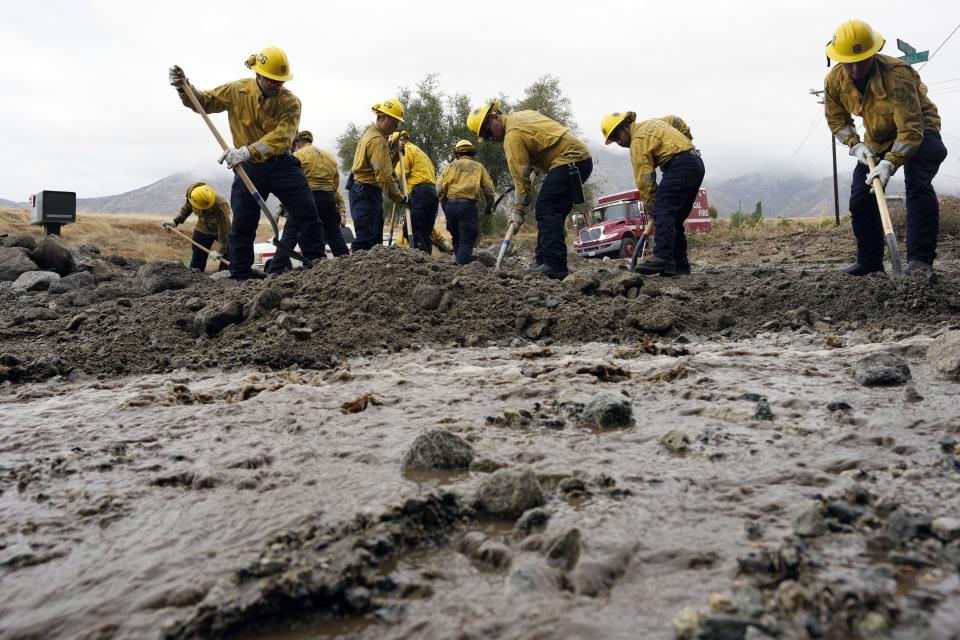 Members of Cal Fire Pilot Rock 6 crew, out of Crestline, Calif., clear mud off the side of the road in the aftermath of Tropical Storm Hilary, Monday, Aug. 21, 2023, in Yucaipa, Calif. | Marcio Jose Sanchez, Associated Press