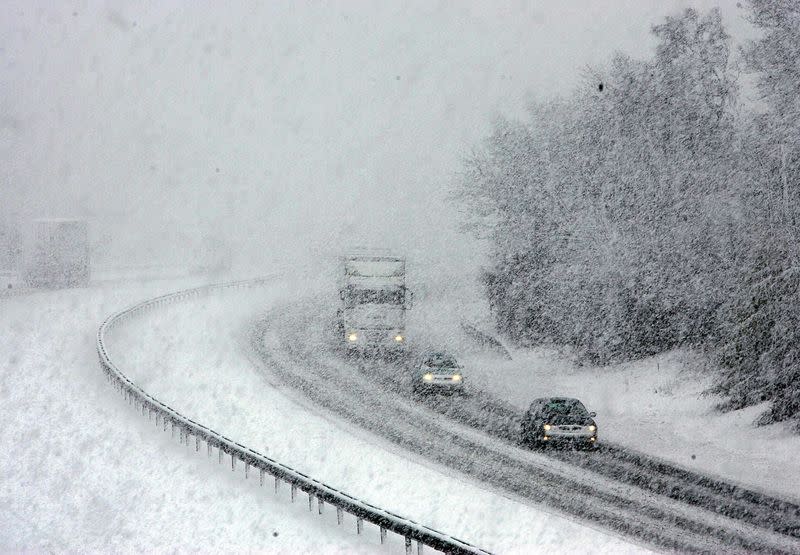 FILE PHOTO: Traffic on the M74 motorway makes its way through the snow near Abington in Scotland