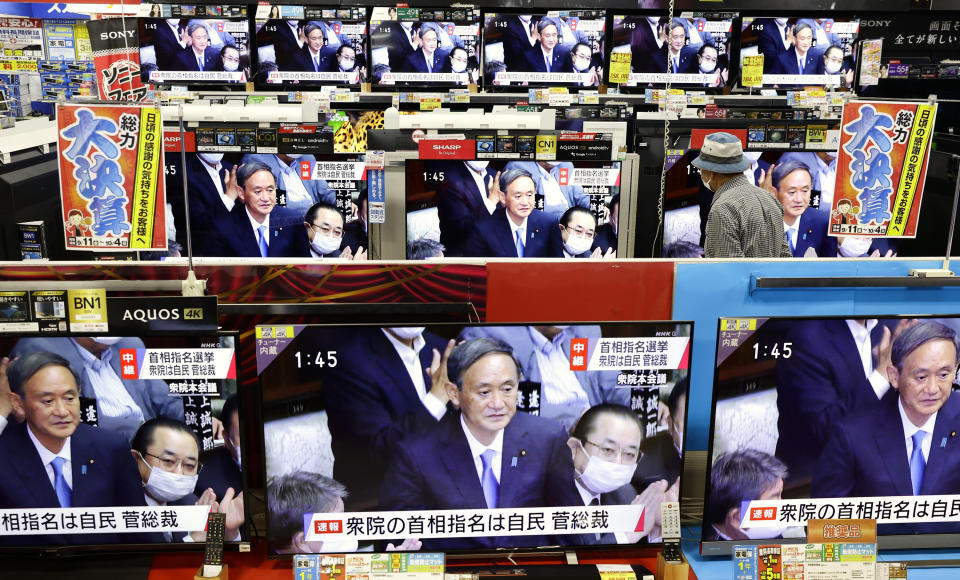 TV sets show a live footage of Yoshihide Suga as he is elected as Japan's new prime minister, at an electric store in Fukuoka, southern Japan Wednesday, Sept. 16, 2020. Japan's Parliament elected Suga as prime minister Wednesday, replacing long-serving leader Shinzo Abe with his right-hand man. (Kyodo News via AP)