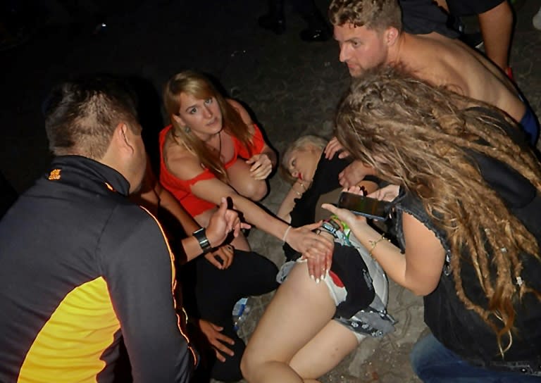 An injured woman is pictured near the Blue Parrot nightclub in Playa del Carmen, Quintana Roo state, Mexico where 5 people were killed, three of them foreigners, during a music festival on January 16, 2017