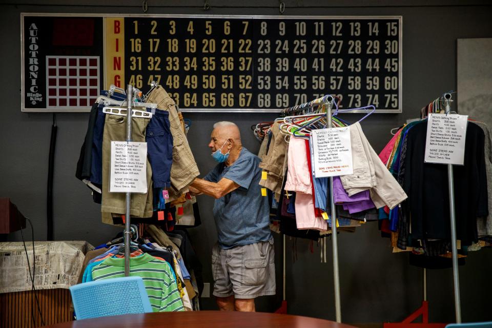 Geza Csurirra looks for clothing from the Desert Rose Thrift Shoppe inside the Desert Hot Springs Senior Center in Desert Hot Springs, Calif., on July 14, 2021. 