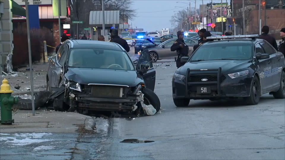 Police officers work at the site of the crash in which Tamia Chappman was killed. - WEWS