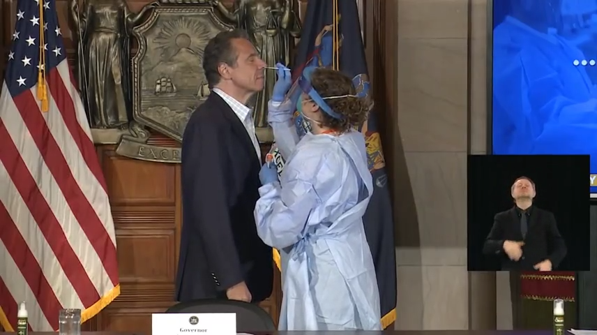 New York Gov. Andrew Cuomo submits to a nasal swab for a COVID-19 test during his daily coronavirus briefing on May 17, 2020.