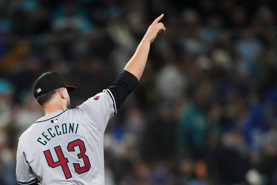Arizona Diamondbacks starting pitcher Slade Cecconi points to center fielder Corbin Carroll after Carroll caught a long fly ball hit by Seattle Mariners' Josh Rojas during the fifth inning of a baseball game Saturday, April 27, 2024, in Seattle. (AP Photo/Lindsey Wasson)