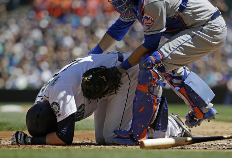 Mets catcher Travis d'Arnaud rushes to aid Mitch Haniger after Haniger was hit by a pitch thrown by Jacob deGrom. (AP)