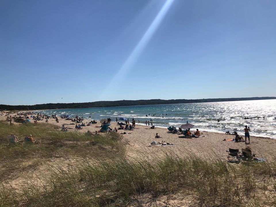 People enjoy a sunny day at the Petoskey State Park beach on Aug. 31, 2024.