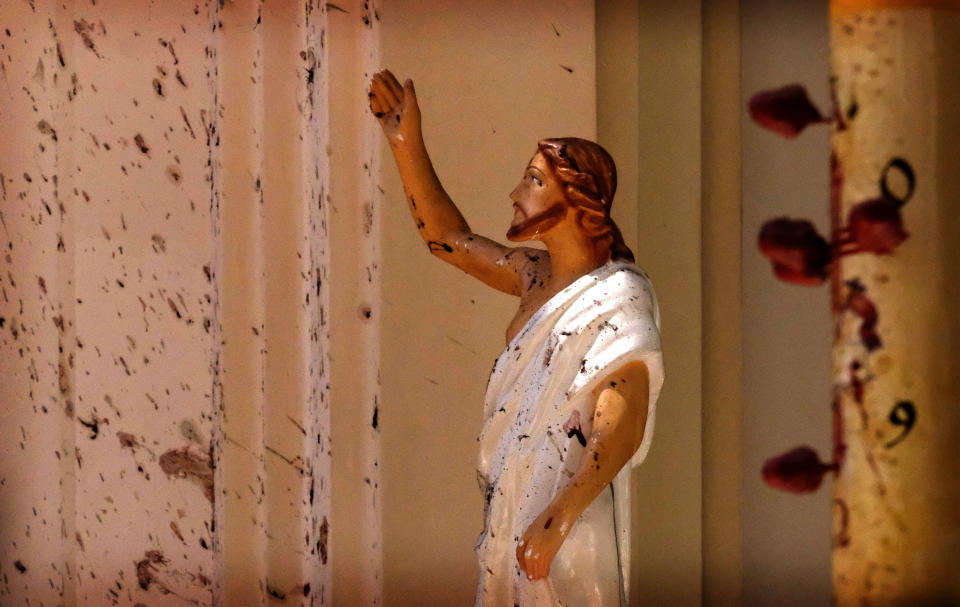 In this April 21, 2019, file photo, bloodstains a Jesus Christ statue at the St. Sebastian's Church after a blast in Negombo, north of Colombo, Sri Lanka. (AP Photo, File)