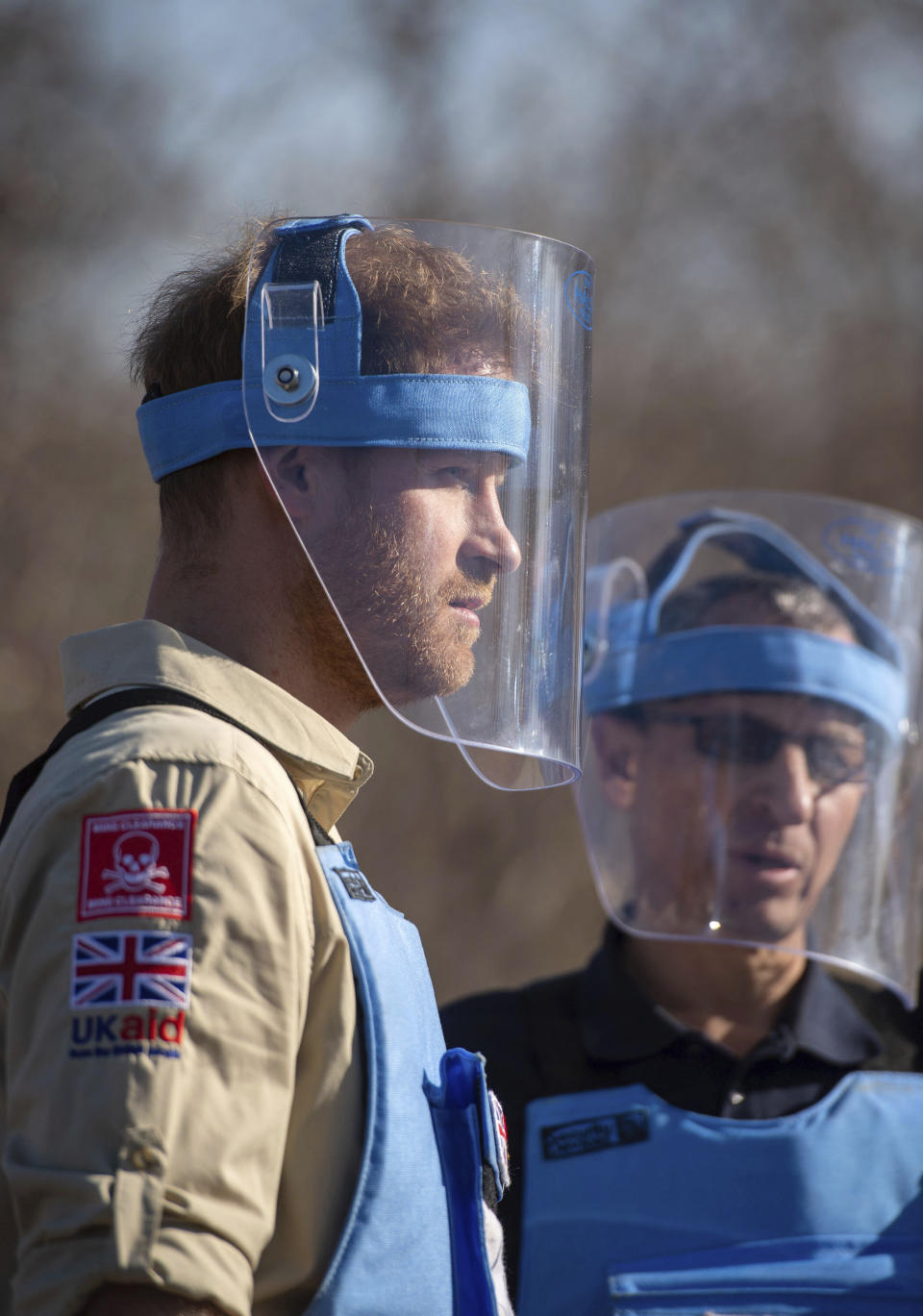 Britain's Prince Harry walks through a minefield in Dirico, Angola Friday Sept. 27, 2019, during a visit to see the work of landmine clearance charity the Halo Trust, on day five of the royal tour of Africa. Prince Harry is following in the footsteps of his late mother, Princess Diana, whose walk through an active mine field in Angola years ago helped to lead to a global ban on the deadly weapons. (Dominic Lipinski/Pool via AP)