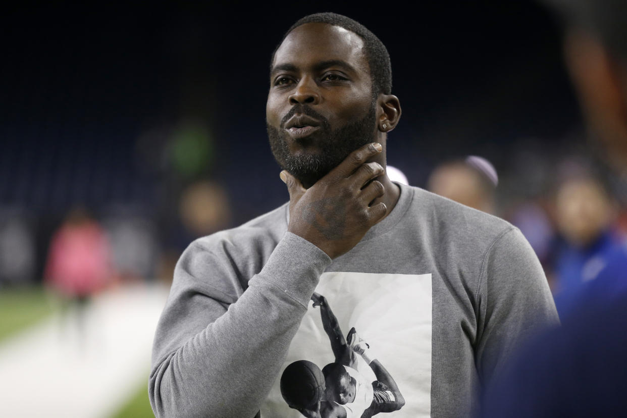 Michael Vick watches an NFL game.