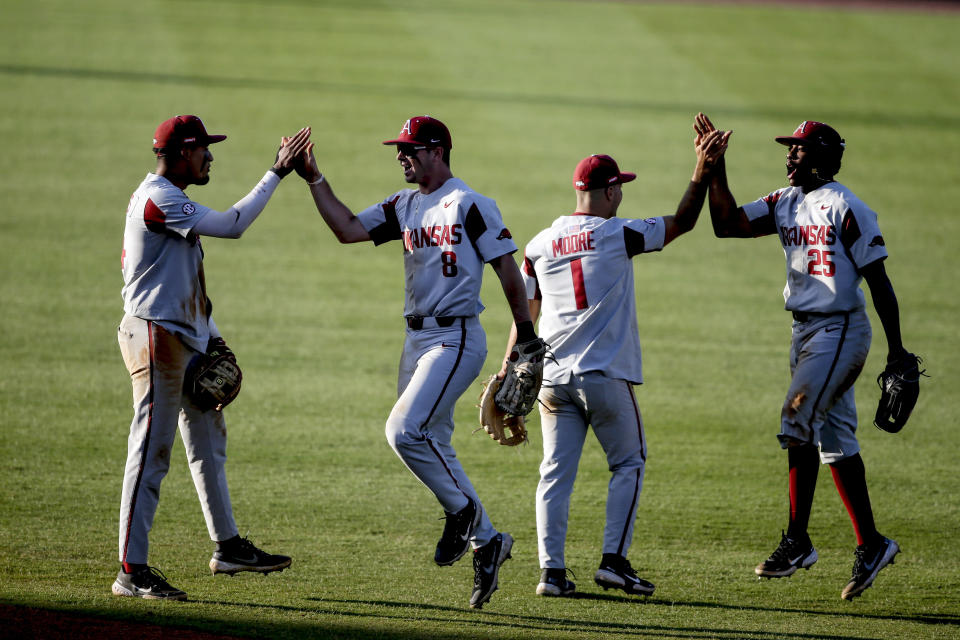 Arkansas players celebrate after they defeated Mississippi 3-2 to advance to the championship game of the Southeastern Conference college baseball tournament Saturday, May 29, 2021, in Hoover, Ala. (AP Photo/Butch Dill)